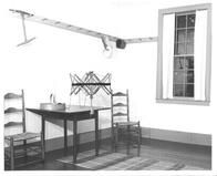 SA0528 - Photo of an exhibit at Dunham Tavern Museum, Cleveland, Ohio, showing the museum's Shaker room: chairs, table, bonnets on pegs, and yarn winder., Winterthur Shaker Photograph and Post Card Collection 1851 to 1921c